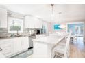Beautiful, bright, modern kitchen with a large island, stainless steel appliances, and backsplash at 1208 Bay Pine Blvd, Indian Rocks Beach, FL 33785