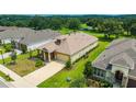 A lovely aerial view of a home with lush lawn, manicured landscaping, and large driveway at 14174 Thoroughbred Dr, Dade City, FL 33525