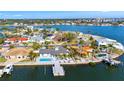 Wide aerial view of a waterfront community with luxurious homes, private docks, and access to the open bay at 1493 Sea Gull S Dr, St Petersburg, FL 33707