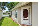 Inviting entryway with a decorative front door and well-maintained landscaping at 19232 Barred Owl Ct, Land O Lakes, FL 34638