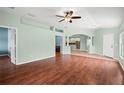 Open concept living room featuring beautiful wood floors, natural lighting, and neutral paint at 19232 Barred Owl Ct, Land O Lakes, FL 34638