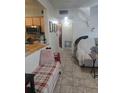 Functional kitchen, hallway, living room area with tile floors and casual seating at 1991 63Rd N Ave, St Petersburg, FL 33702