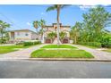 Charming two-story home featuring lush landscaping and a long driveway at 2149 Bayou Grande Ne Blvd, St Petersburg, FL 33703