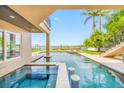 Backyard view of swimming pool with swim up bar and waterfront access at 2149 Bayou Grande Ne Blvd, St Petersburg, FL 33703