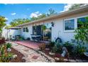 Backyard patio with garden beds and outdoor furniture, perfect for relaxing or entertaining guests at 2200 Marshall Dr, Dunedin, FL 34698