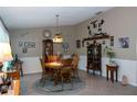 Cozy dining room with round wooden table and chairs, complemented by a vintage chandelier at 2200 Marshall Dr, Dunedin, FL 34698