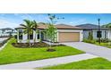 Inviting single-Gathering home featuring lush green lawn and mature trees enhancing the curb appeal at 2760 Winding Creek Trl, North Port, FL 34289