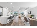 Bright, open-concept living area with wood floors and a view of the outdoor patio at 2760 Winding Creek Trl, North Port, FL 34289