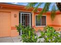 Close up of home entrance and blooming vegetation at 413 Blackburn Rd, Nokomis, FL 34275