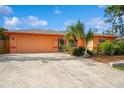 Single-story home with an attached two-car garage and long driveway at 413 Blackburn Rd, Nokomis, FL 34275