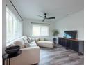 Comfortable living room with a plush sofa, modern ceiling fan, and stylish accents at 4507 26Th S Ave, Tampa, FL 33619