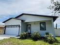 Attractive single-level residence with a spacious driveway, manicured garden, and welcoming front porch at 5180 69Th N Ave, Pinellas Park, FL 33781