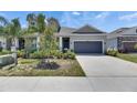 Attractive single-Gathering home with a two-car garage, tidy landscaping, and a concrete driveway at 5814 Stockport St, Riverview, FL 33578