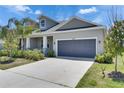 Beautiful home featuring a gray exterior, a two-car garage, and a well-maintained front yard at 5814 Stockport St, Riverview, FL 33578