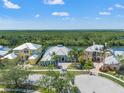 Beautiful homes with metal roofs, lush landscaping, and a scenic view of the natural waterways from above at 819 Islebay Dr, Apollo Beach, FL 33572
