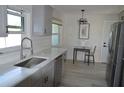 Well-lit kitchen featuring a modern sink, new appliances, a breakfast table, and wood-look floors at 9093 108Th St, Seminole, FL 33772