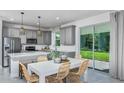 Eat-in kitchen with stainless appliances, island with seating, and sliding doors to backyard at 9754 Redwood Heights Loop, Thonotosassa, FL 33592