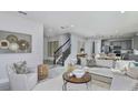 Bright, open-concept living room flowing into kitchen with modern decor and fixtures at 9754 Redwood Heights Loop, Thonotosassa, FL 33592