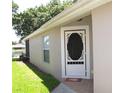 Inviting home entrance featuring a decorative storm door and brick walkway at 19232 Barred Owl Ct, Land O Lakes, FL 34638