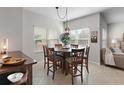 Bright dining room featuring an ornate chandelier, a round table and seating for six guests at 10764 70Th Ave # 1205, Seminole, FL 33772