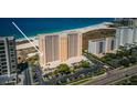 Picturesque view of a high rise on a white sand beach near a beautifully landscaped parking area at 1270 Gulf Blvd # 501, Clearwater Beach, FL 33767