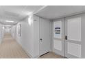 Hallway of a condo with a decorative door that says 