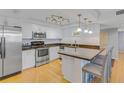 Modern kitchen featuring stainless steel appliances, granite countertops, and a breakfast bar with seating at 1460 Gulf Blvd # 406, Clearwater Beach, FL 33767