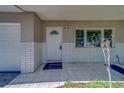 Inviting front porch features white tile flooring, brick accents, and a charming front door at 1710 S Lake Ave, Clearwater, FL 33756