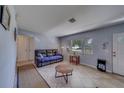 Bright living room with neutral walls, tile flooring, and abundant natural light from a large window at 1710 S Lake Ave, Clearwater, FL 33756