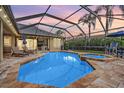 Relaxing screened-in pool and spa with brick pavers, lounge chairs, and outdoor dining area at 19708 Wellington Manor Blvd, Lutz, FL 33549