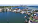 Stunning aerial view of waterfront home with private dock, lush landscaping, and city views in the distance at 442 22Nd Se Ave, St Petersburg, FL 33705