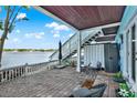 Relaxing outdoor patio with stylish seating, waterfront views, and convenient access to the upper level at 5007 Starfish Se Dr # A, St Petersburg, FL 33705