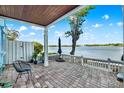 Inviting outdoor patio featuring brick pavers, comfortable seating, and panoramic waterfront views at 5007 Starfish Se Dr # A, St Petersburg, FL 33705