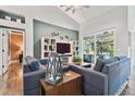 Inviting living room boasts vaulted ceilings, stylish decor, and a sliding glass door to the lanai at 5416 Twin Creeks Dr, Valrico, FL 33596