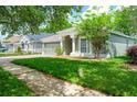 Inviting single-story home with landscaped front yard, two-car garage, and shade trees in a quiet neighborhood at 5902 War Admiral Dr, Wesley Chapel, FL 33544