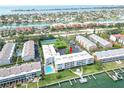 Expansive aerial view of waterfront condos with a pool, tennis court and Gulf views at 719 Pinellas Bayway S # 309, Tierra Verde, FL 33715