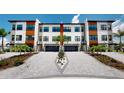 Stunning townhome exterior featuring modern design, lush landscaping, and a welcoming curb appeal at 772 Gran Kaymen Way, Apollo Beach, FL 33572