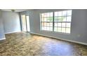 Bright living room featuring tile floors, a large window for natural light, and access to the outdoors at 8054 Spring Hill Dr, Spring Hill, FL 34606