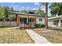 Quaint single-story home with a brick front porch and walkway at 811 E Flora St, Tampa, FL 33604