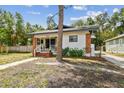 Home's front exterior highlighting the brick detail and porch at 811 E Flora St, Tampa, FL 33604