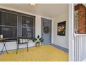 Inviting front porch with a striped rug, seating, and charming Seminole Heights sign at 811 E Flora St, Tampa, FL 33604