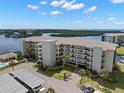 Waterfront condo building featuring convenient covered parking, well maintained landscaping, and water views at 8141 Aquila St # 346, Port Richey, FL 34668