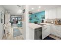 Open floor plan showcases a kitchen that flows to the living room and balcony at 8141 Aquila St # 346, Port Richey, FL 34668