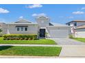 Charming single-Gathering home featuring manicured lawn and beautiful landscaping under a sunny sky at 8919 Drummer Plank Dr, Wesley Chapel, FL 33545