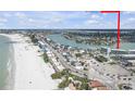 Stunning aerial view showcases the beachfront location and the nearby intercoastal waterway at 9815 Harrell Ave # 502, Treasure Island, FL 33706