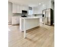 Bright kitchen featuring white cabinets, stainless steel appliances, and a large island at 1002 E North Bay St, Tampa, FL 33603