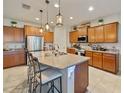 Bright kitchen with granite counters, center island, stainless steel appliances, and wooden cabinetry at 10404 Scarlet Chase Dr, Riverview, FL 33569