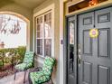 Inviting front porch with seating area and a decorative 'Welcome' sign on the front door at 10501 Dotham Ct, Tampa, FL 33626