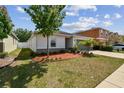 Charming one-story home with well-maintained lawn, landscaping, and inviting curb appeal at 10603 Massimo Dr, Wimauma, FL 33598