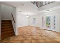 Bright foyer with decorative glass front door, grand staircase, and tiled flooring at 13420 Copper Head Dr, Riverview, FL 33569